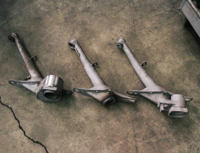 From left to right: An updated Emory trailing arm, a worn 911 arm and an unused 911 arm.