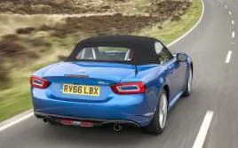 Fiat 124 Spider driving, roof up 